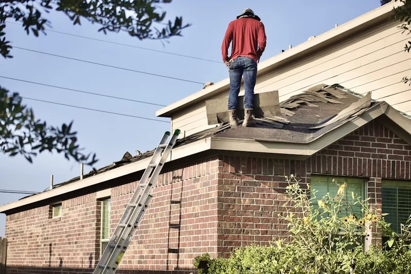 Professional roofer working on a residential roof in North Plainfield